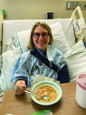 Jennifer Fagan prepares to eat a meal while recovering in her hospital bed.