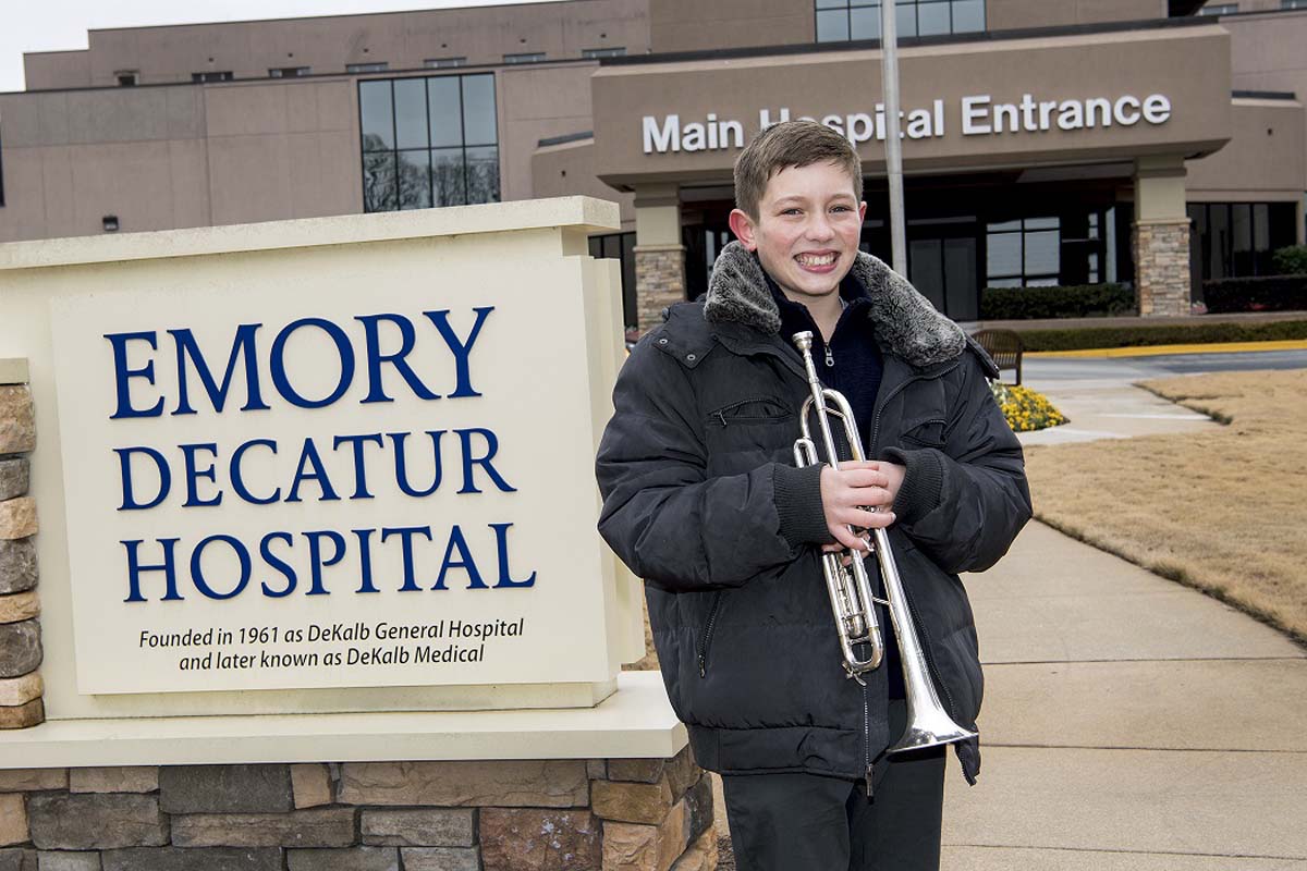 Jason Zgonc holds a trumpet outside of Emory Decatur Hospital